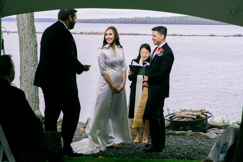 Bride and Groom during ceremony with another man near them | Wedding Photography