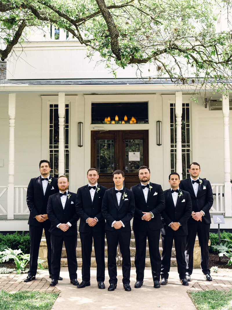 groom with groomsmen in black tuxedos