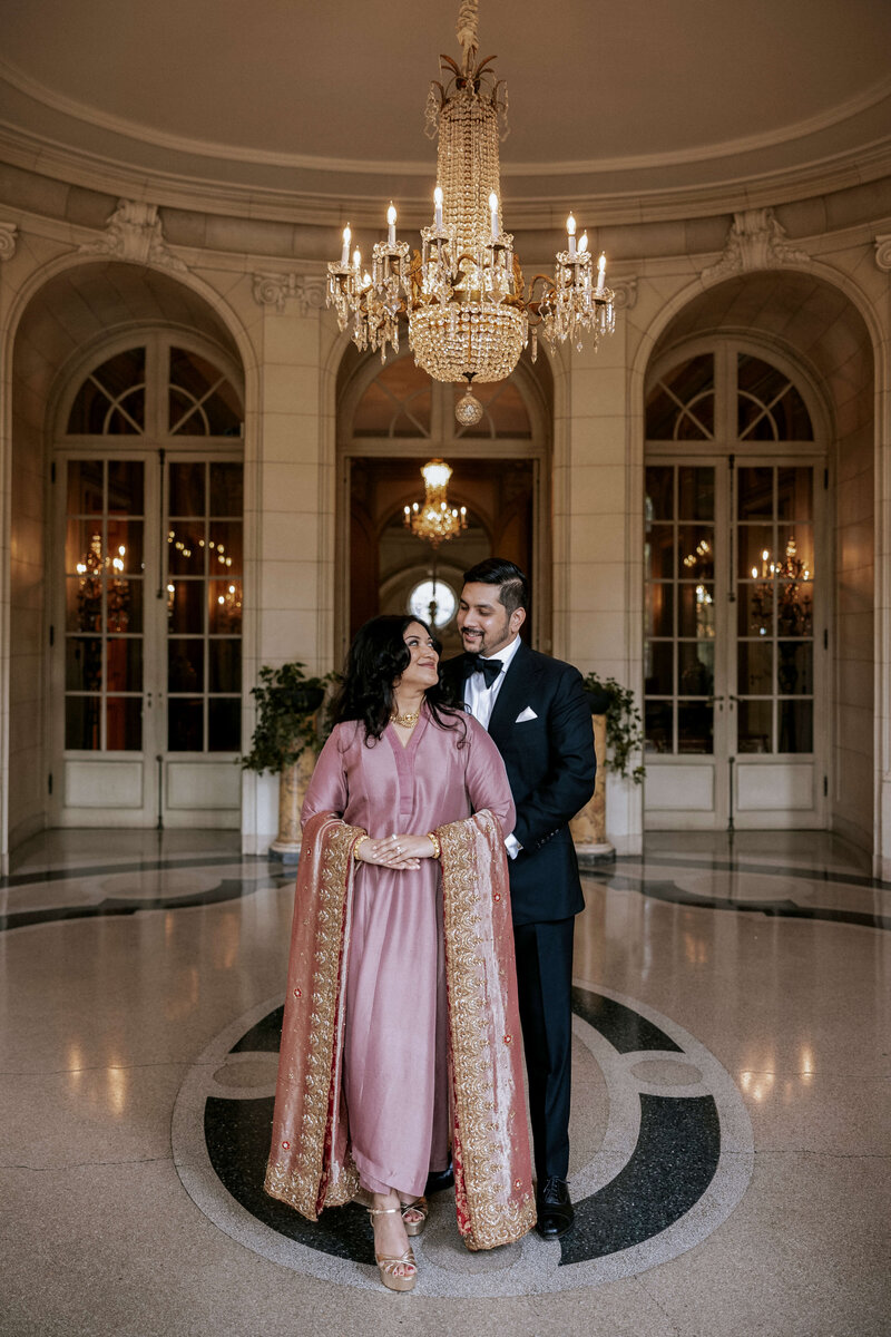 elegant-couple-posing-under-chandelier