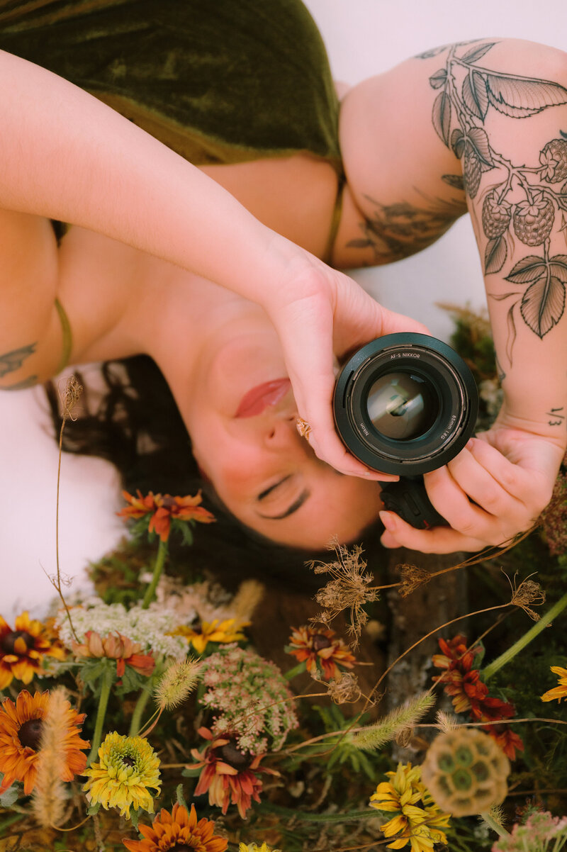 Colleen is upside down holding a camera
