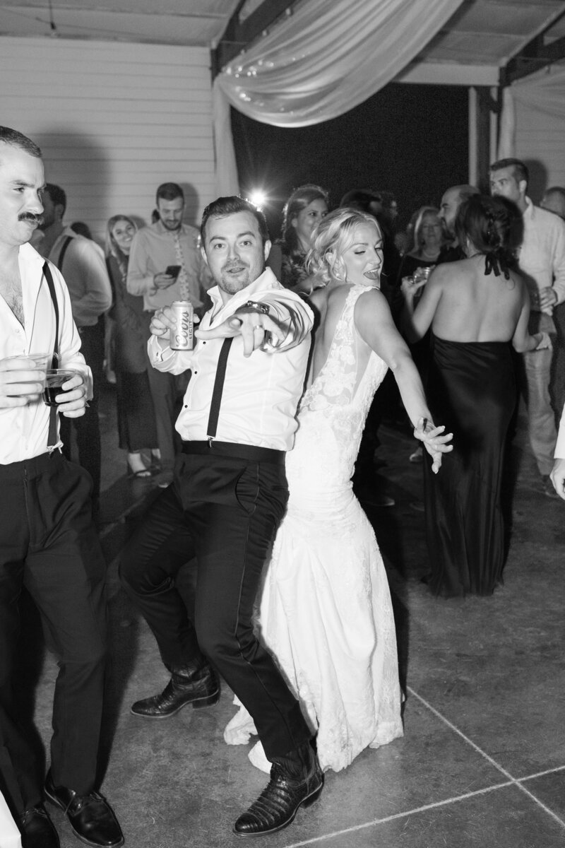 Nick and Lauren dancing at their reception in the barn at Younger Ranch wedding venue.
