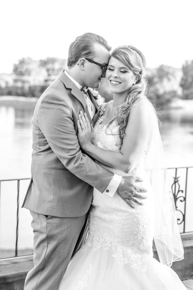 Black and white photo of bride and groom snuggling