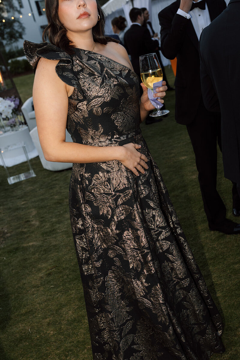 Wedding guest elegantly dressed holding cocktail