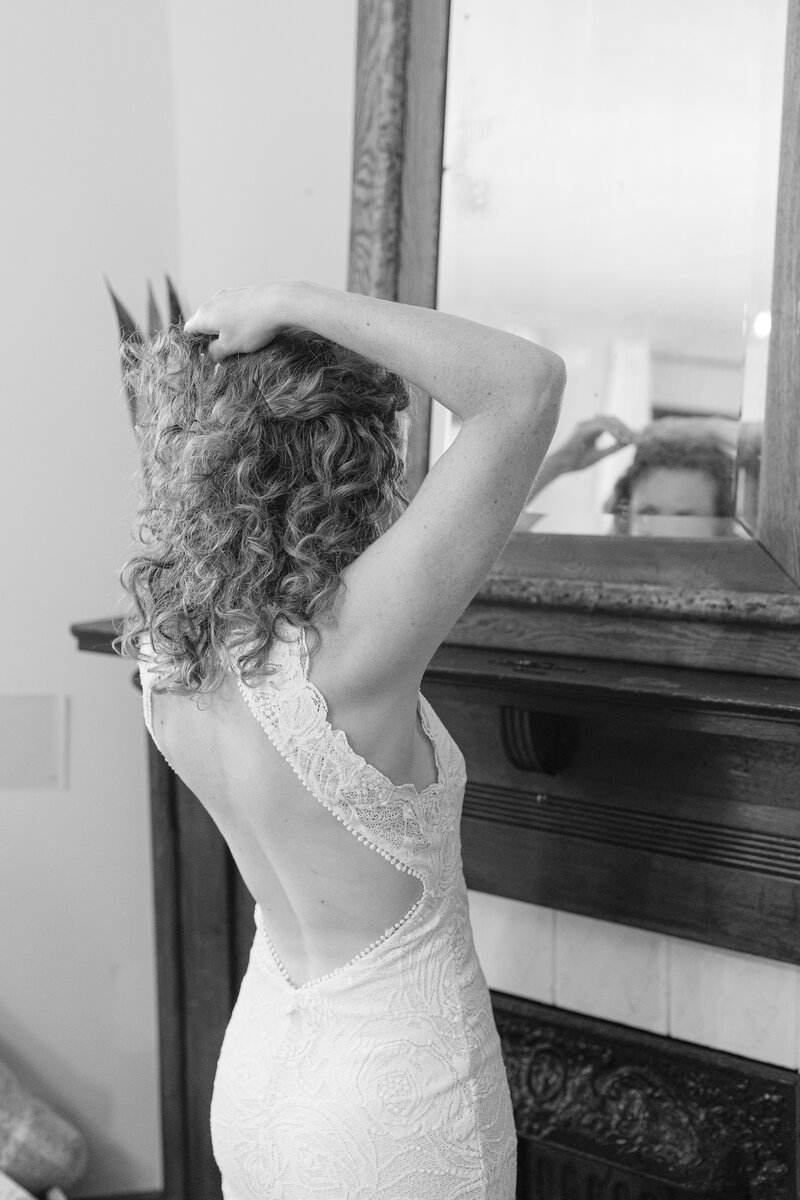 bride getting ready in front of mirror