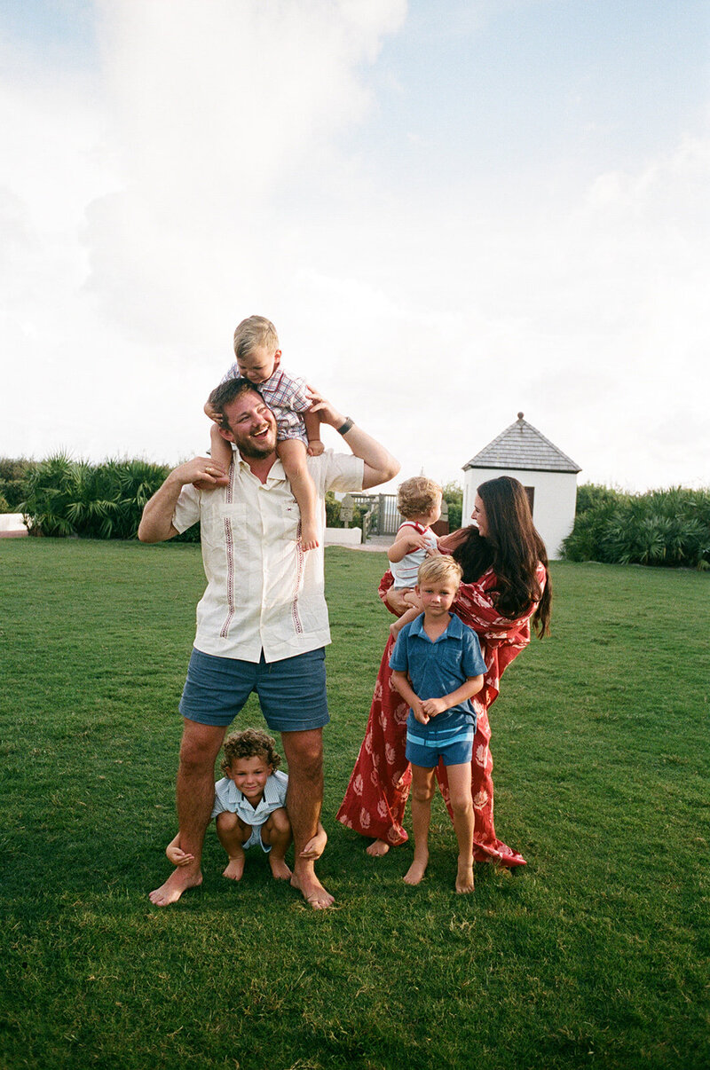 35mm film photo of a family of 6 playfully interacting