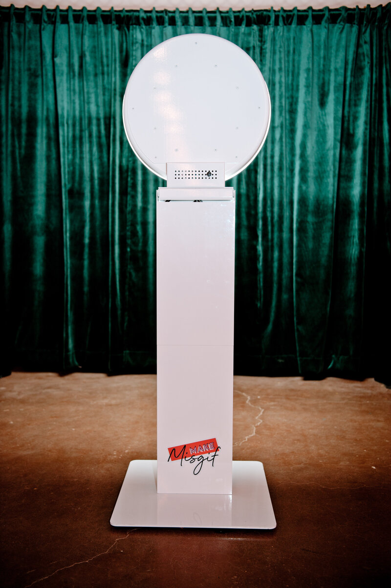 Sleek white MISGIF photo booth with ring light setup in front of green curtain backdrop, perfect for corporate events and brand activations in Phoenix, Arizona