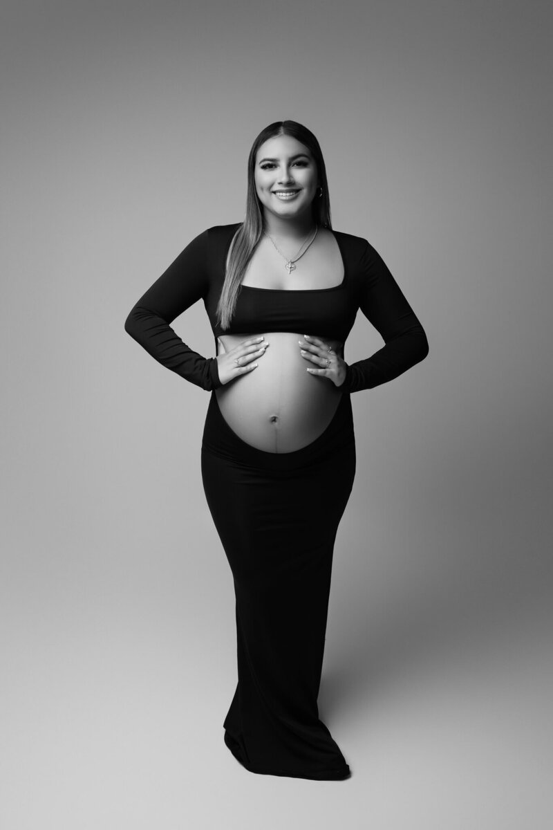 Modern black maternity gown with full back cutout showcasing bare bump