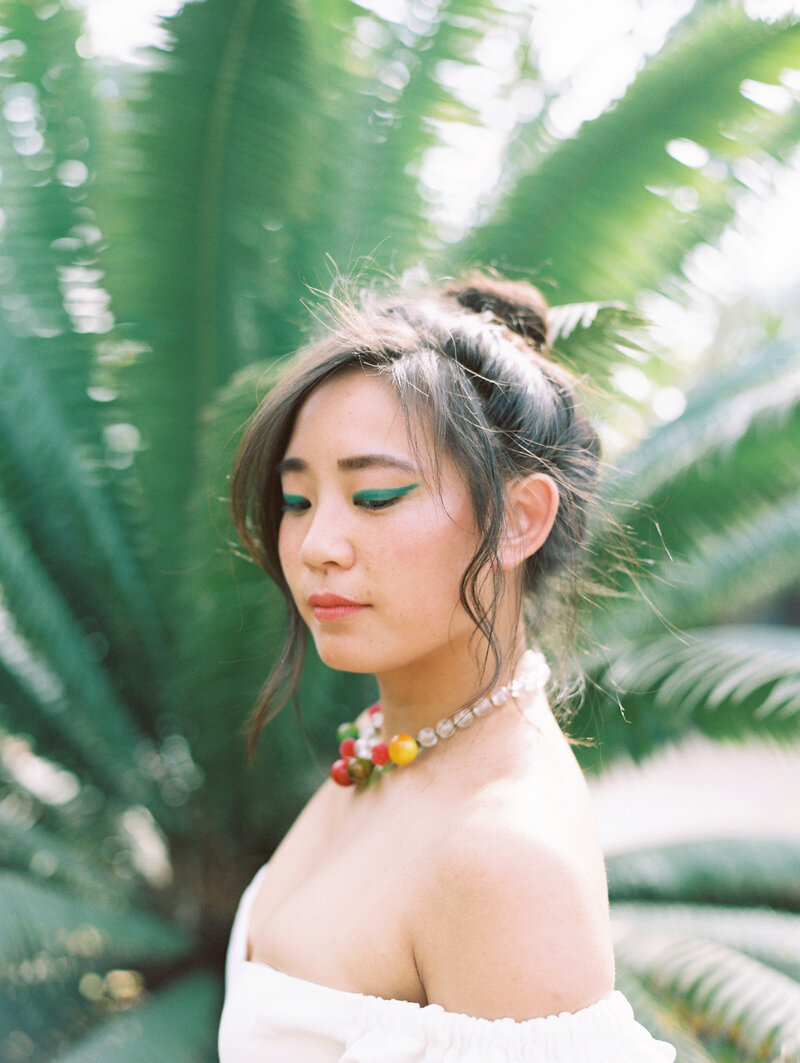 A solo portrait of the stunning bride in the scenic venue Dos Pueblos Orchid Farm in Santa Barbara, along the California Coast, on film by photographer Megan Lynn of My Sun and Stars Co.