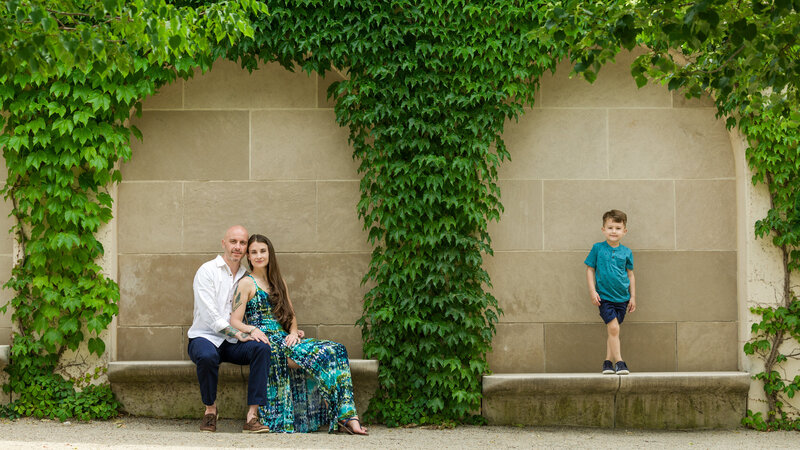 A family enjoying the beautiful landscapes of Longwood Gardens, captured during a spring or autumn mini session near Philadelphia.