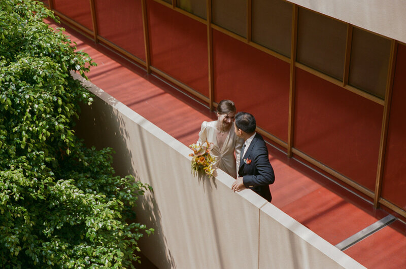 Couple standing on upper walkway at Marin Civic Center courthouse.