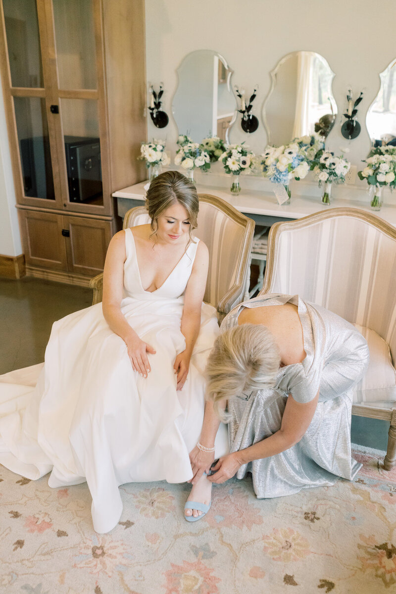 Bride getting ready in Canyonwood Ridge bridal suite with natural light and soft details