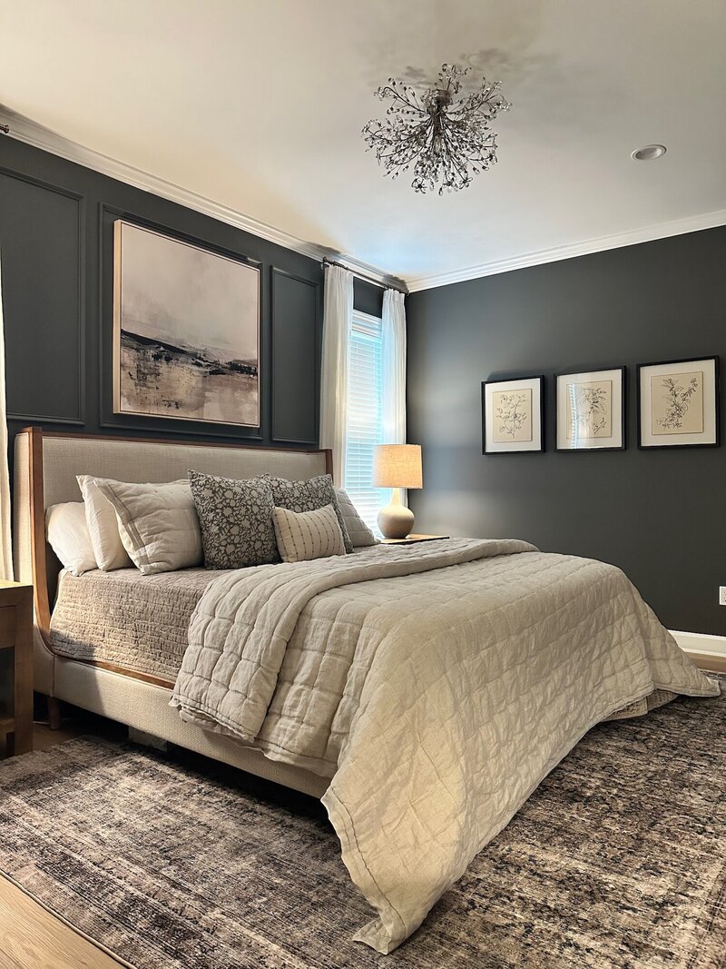 Bed with plush linens and layers of textured pillows.