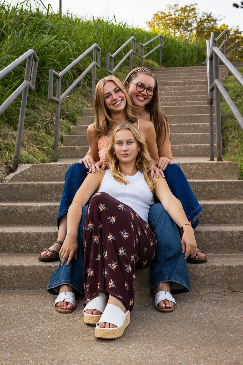 MBP Senior Team sitting on the stairs in a line smiling at the camera in Lawrence, KS