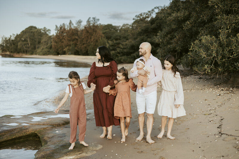 A gorgeous family of four girls with their parents at the beach
