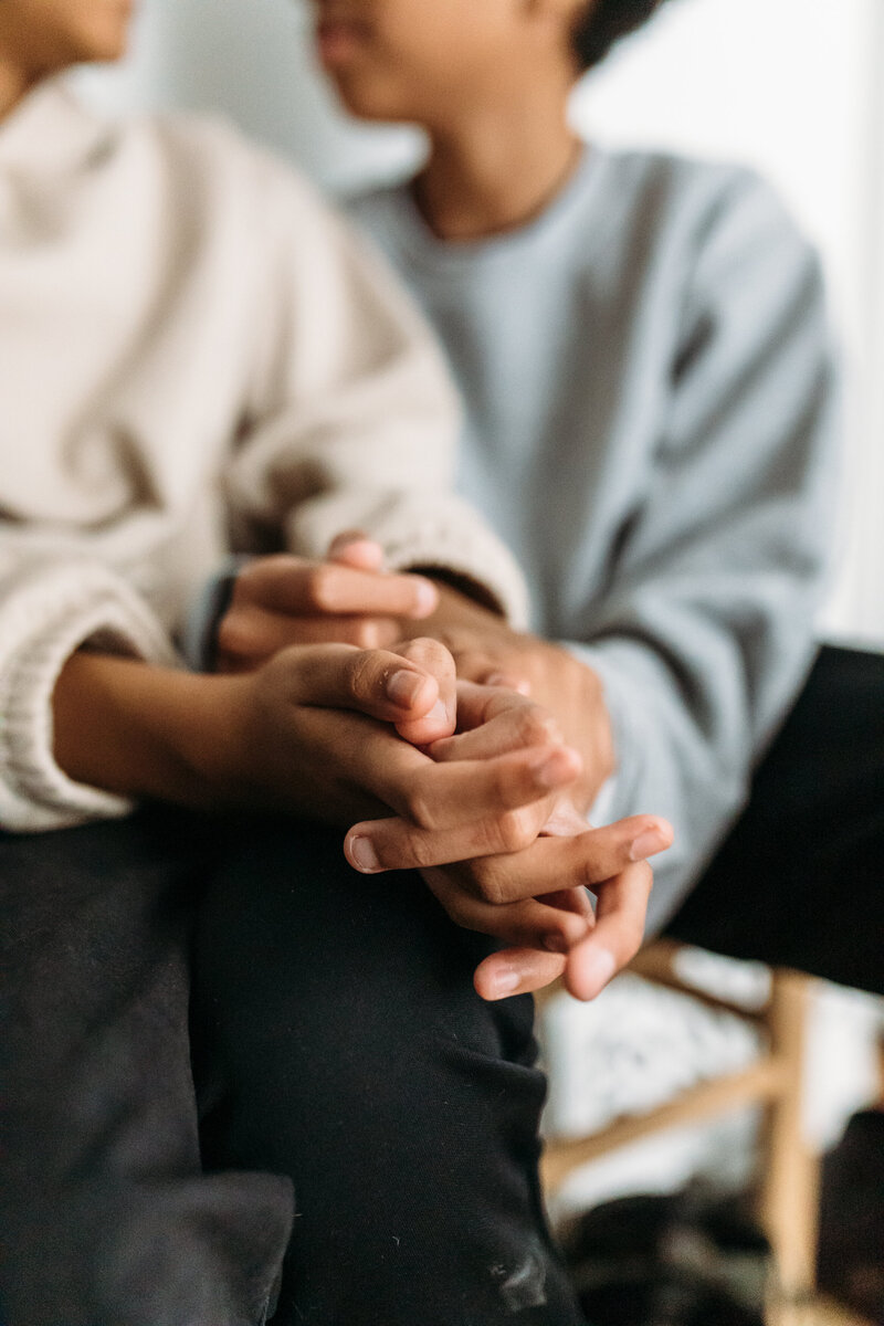 Family Photographer, two people hold hands happily