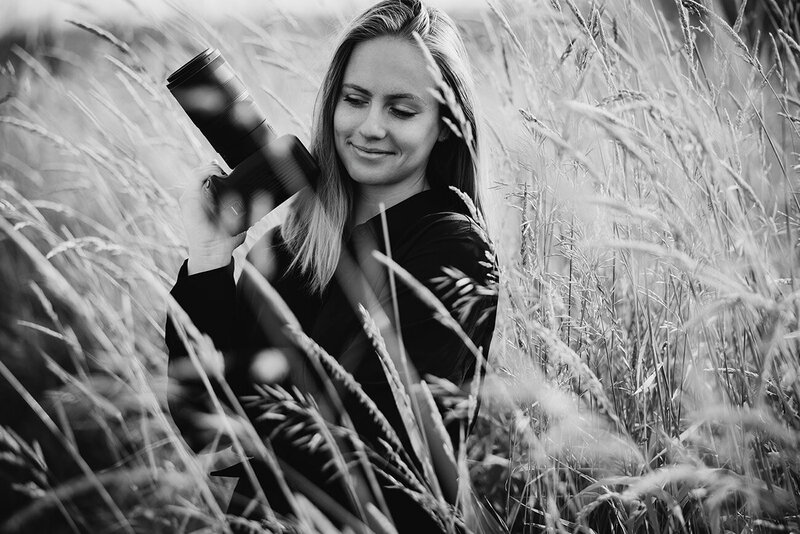 Caitlyn Kloeckl Photography with her camera in the grass profile picture.