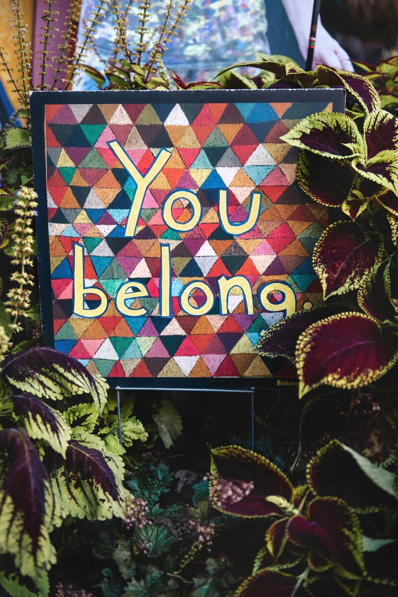 An inspiring art installation featuring the words "You Belong" in colorful paper, emphasizing inclusion and belonging.