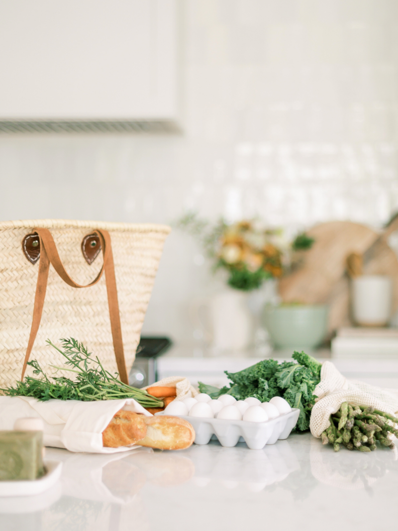Soft kitchen counter with fresh greens, bread, and eggs in natural light, creating a clean and welcoming background for Type Won Coaching™ site menu