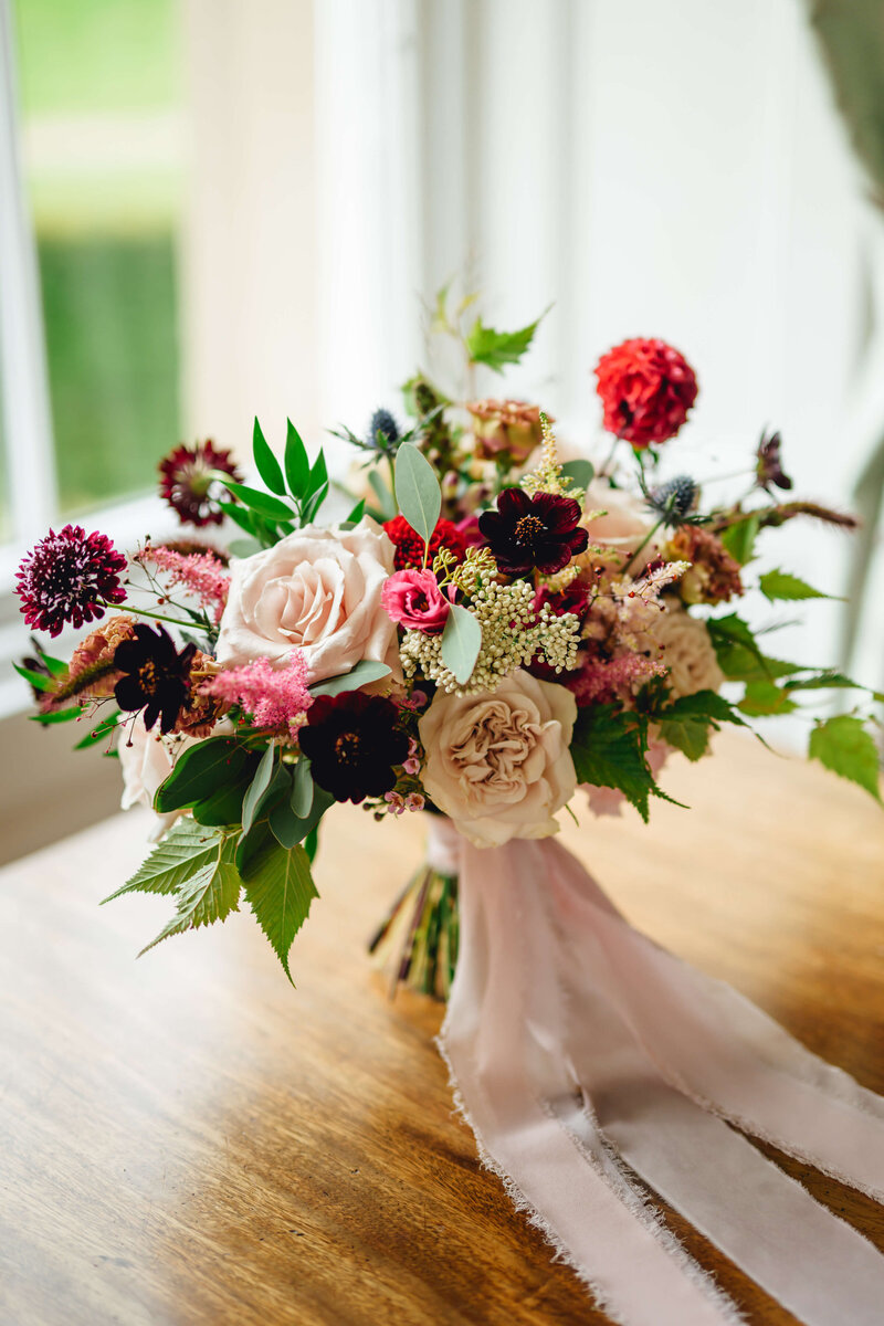 Bridal flowers of scabiosa, pink roses, chocolate cosmos