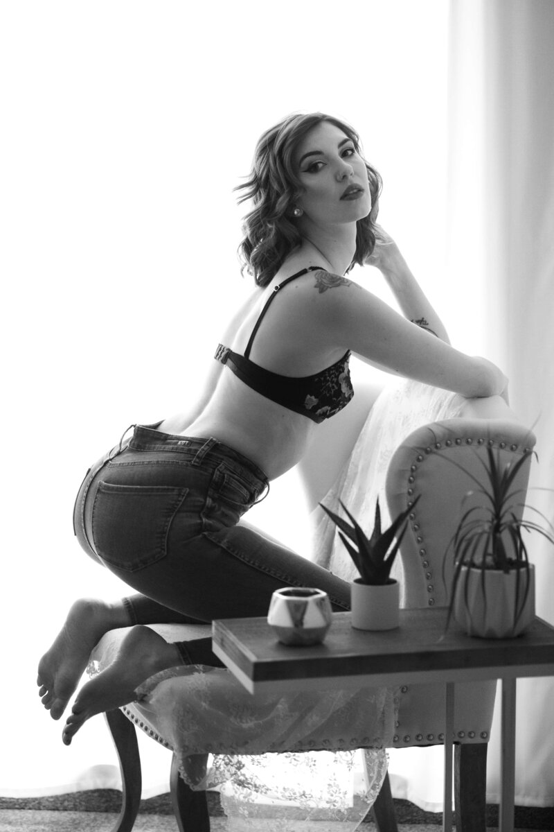 Colorado Springs Boudoir Photographer woman on chair in jeans and bra