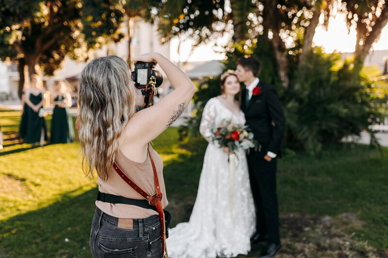 A candid photo of a wedding photographer working