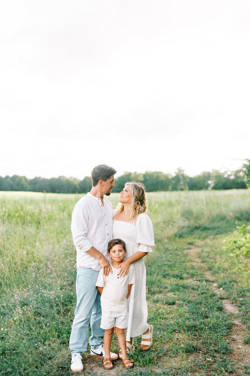 A sweet moment of a mom holding her baby's hand during a Dallas family photography session.