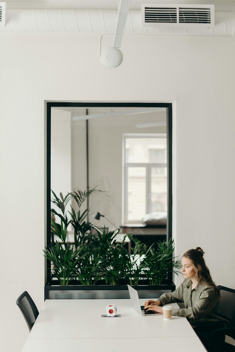 woman sitting at a desk working on computer