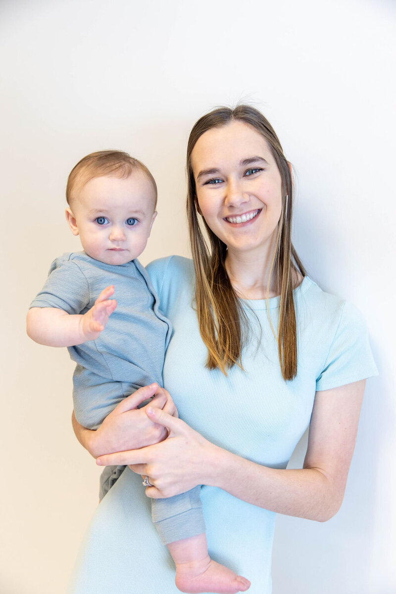 Women smiling as she holds her toddler