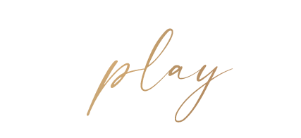 play  written in brushed gold script font