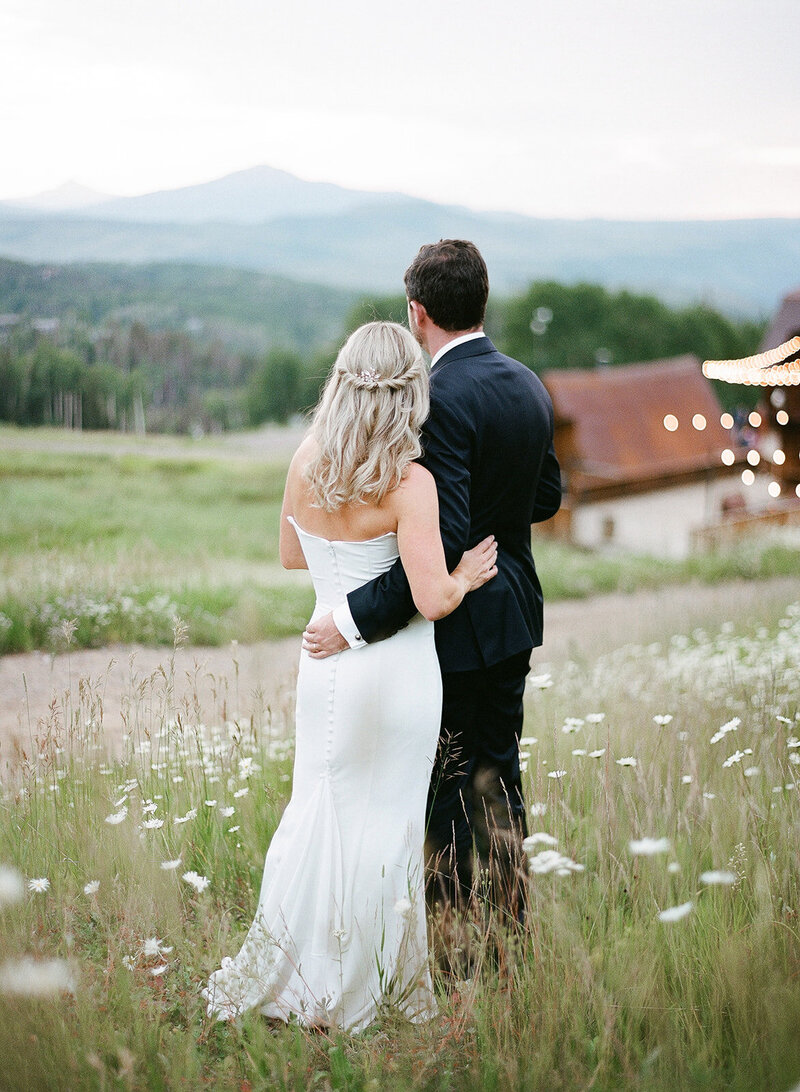 Couple embraces looking out into the horizon at Gorrono Ranch in Telluride, Colorado.