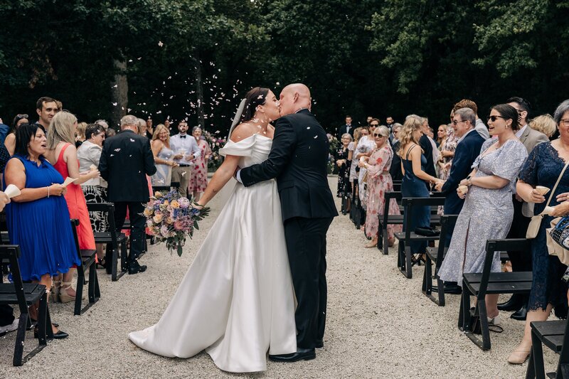 a bride and groom kiss in the aisle at bangor farm near darfield during their wedding