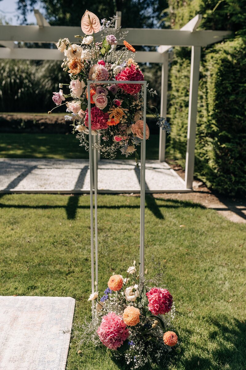 floral installation at wedding ceremony christchurch pink orange babys breath nz