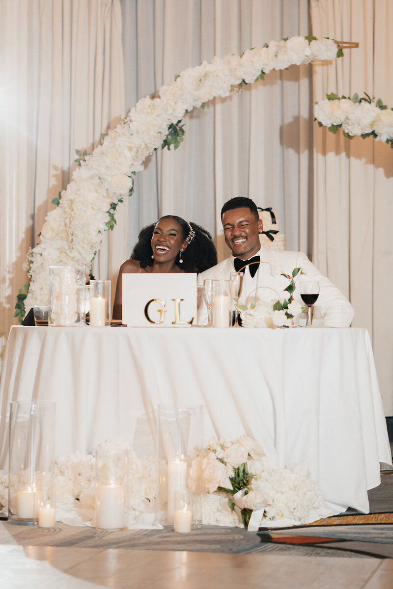 black bride and groom at wedding reception smiling