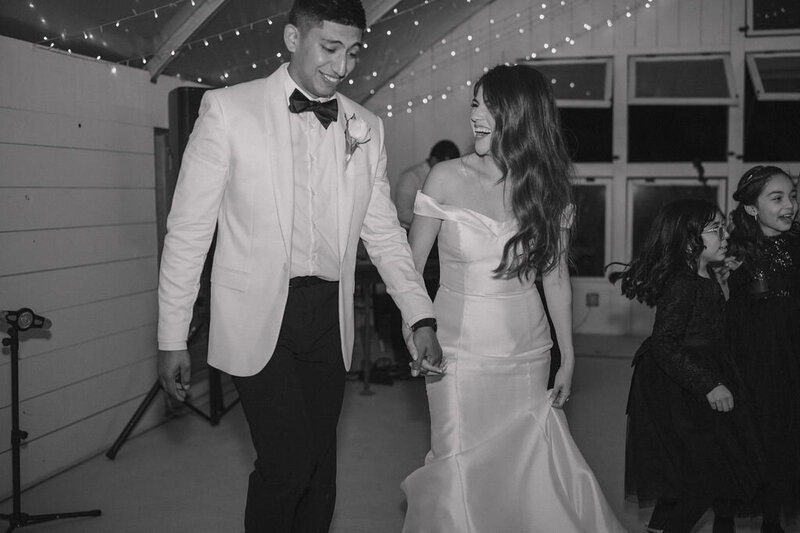 bride and groom holding hands