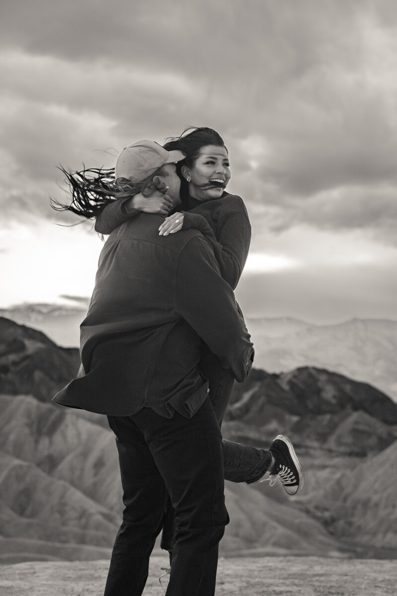 Black and white photo of a person holding their partner up