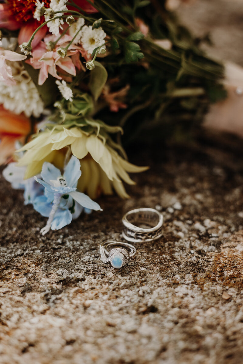 wedding ring next to bouquet of flowers