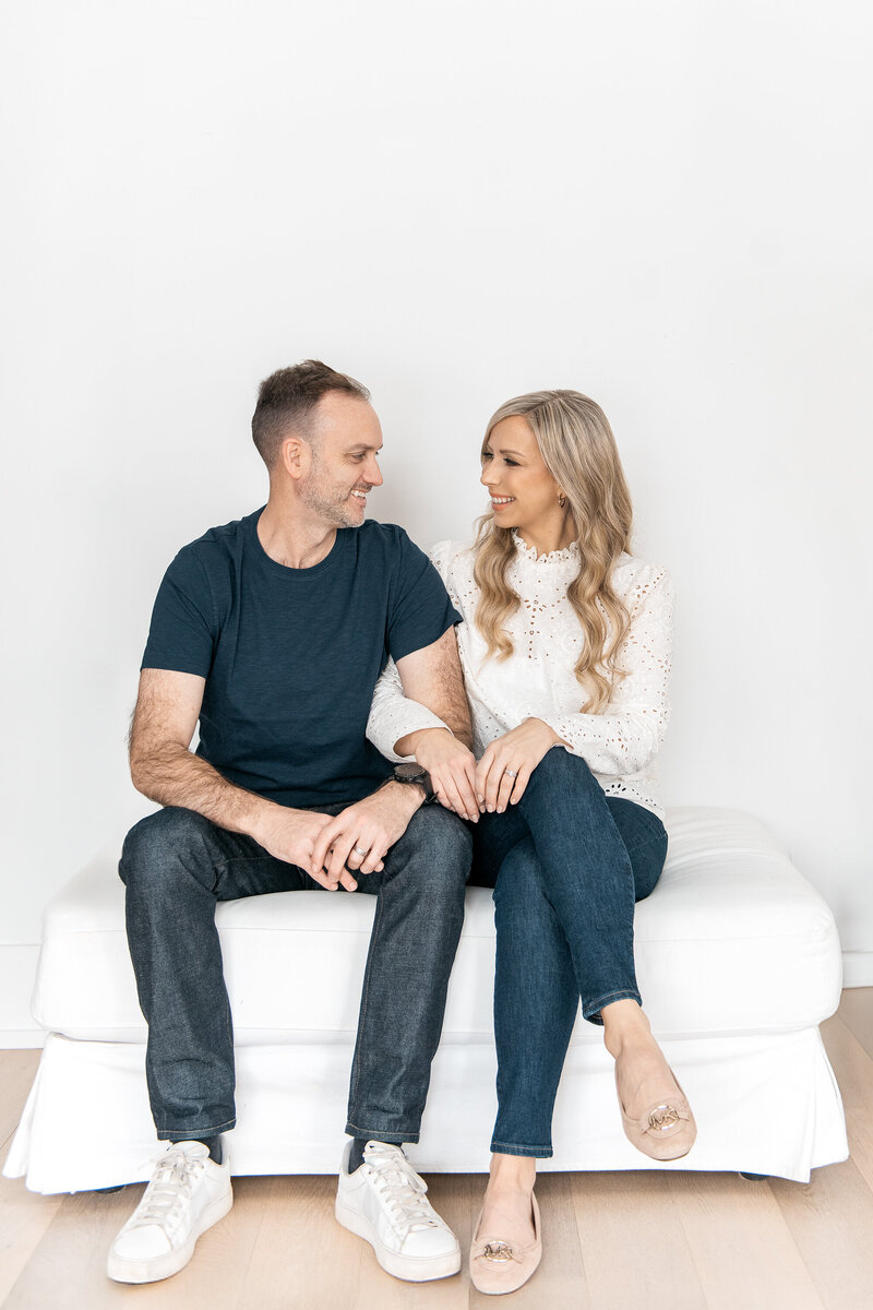 Man and woman on couch smiling