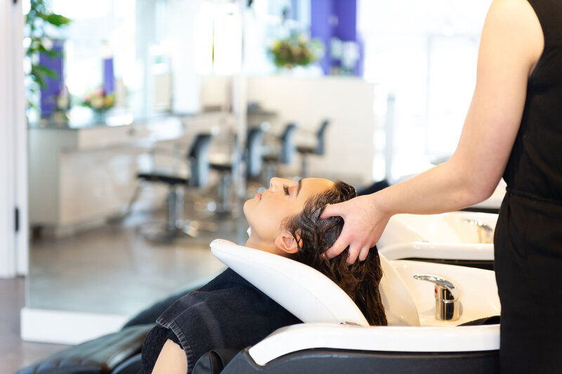 Client with eyes closed receives luxurious Vivid wash and massage