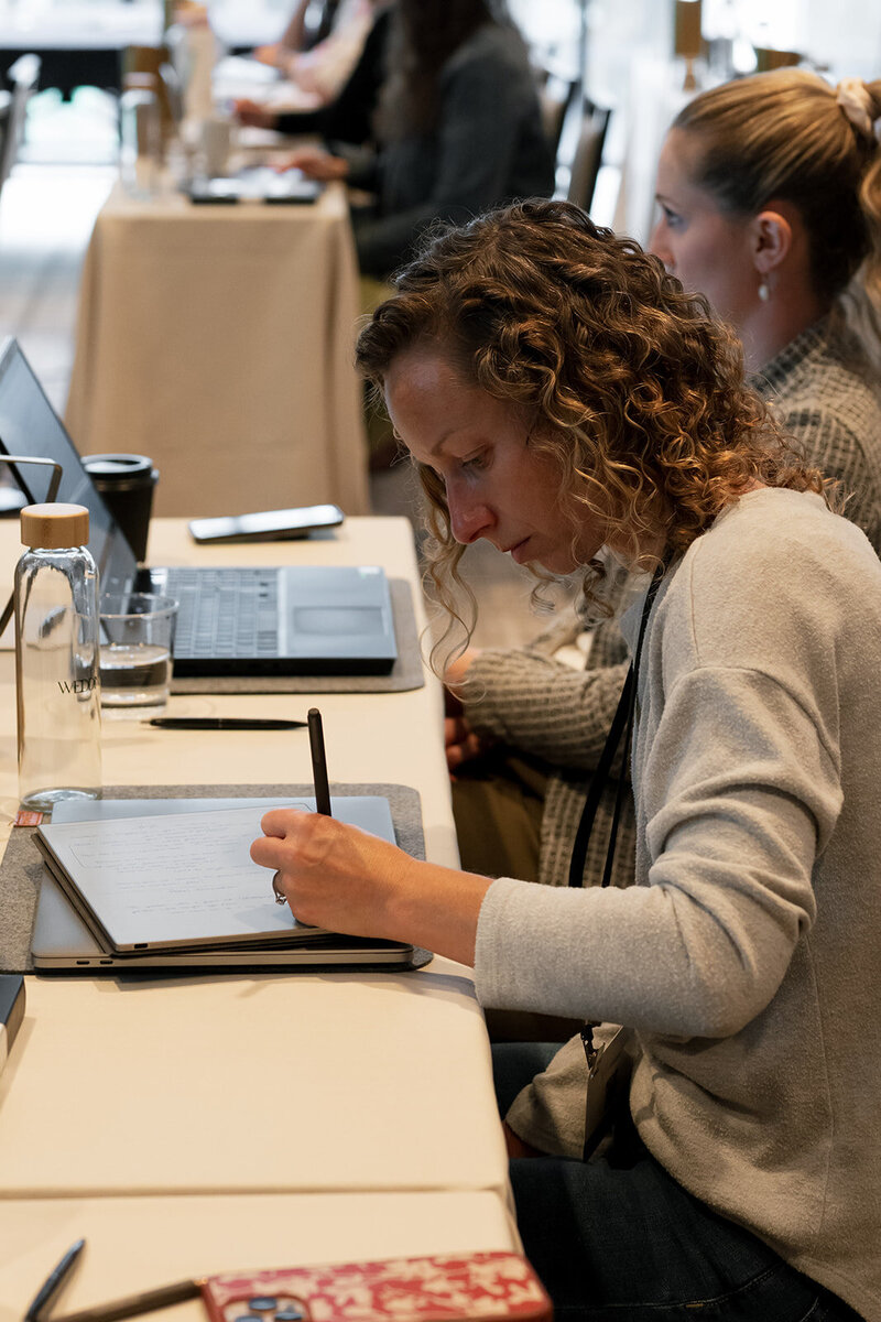 wedding pro taking notes at conference