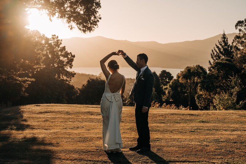 bride and groom dance on akaroa lawn at sunset at mt vernon on their wedding day