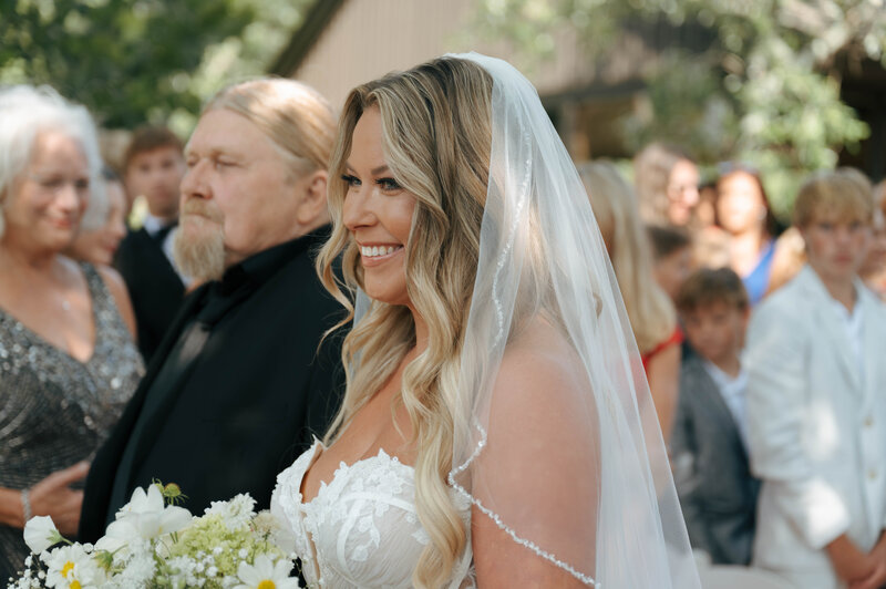 Outdoor wedding ceremony at the Darby House of the bride walking down the aisle