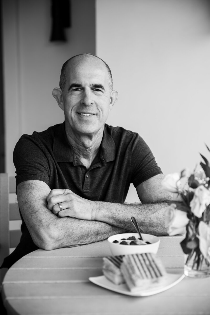 Black and white photo of Dr. Bobby sitting at a table