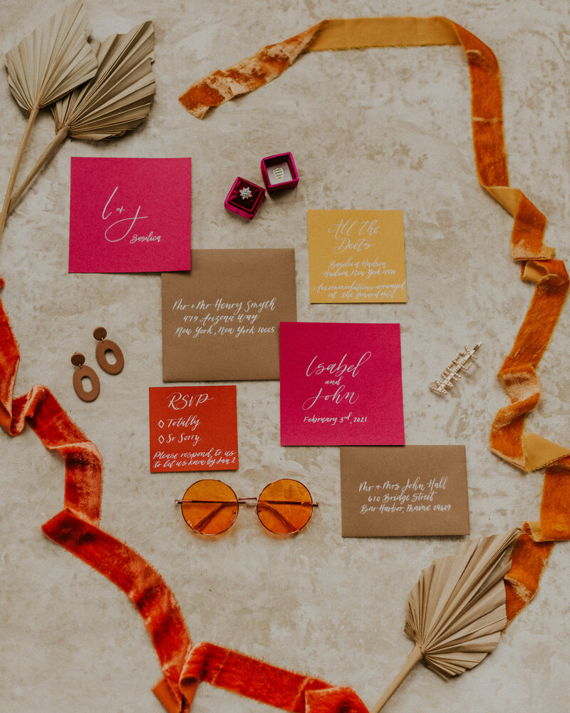 bright pink and orange wedding invitations and engagement ring
