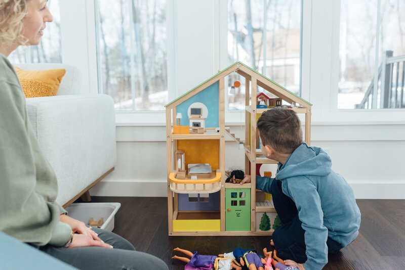Toddler playing with play house