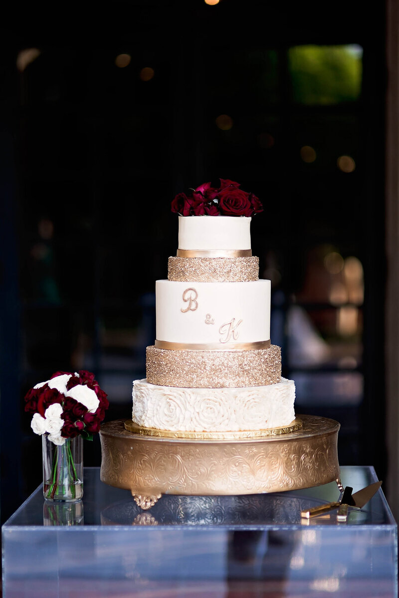 Swank Soiree Dallas Wedding Planner Kerri and Bravion at the Dallas Arboretum and Botanical Garden - White and gold wedding cake with red roses