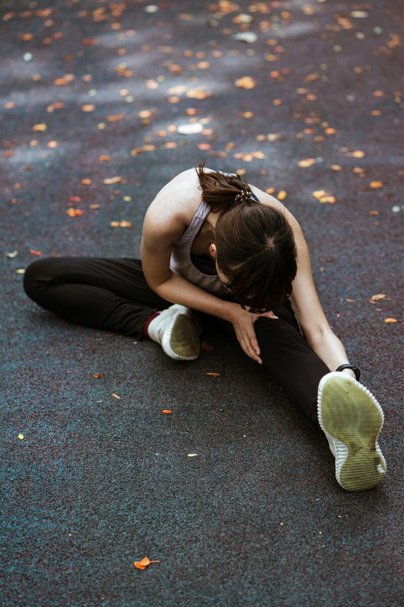 woman stretching on ground