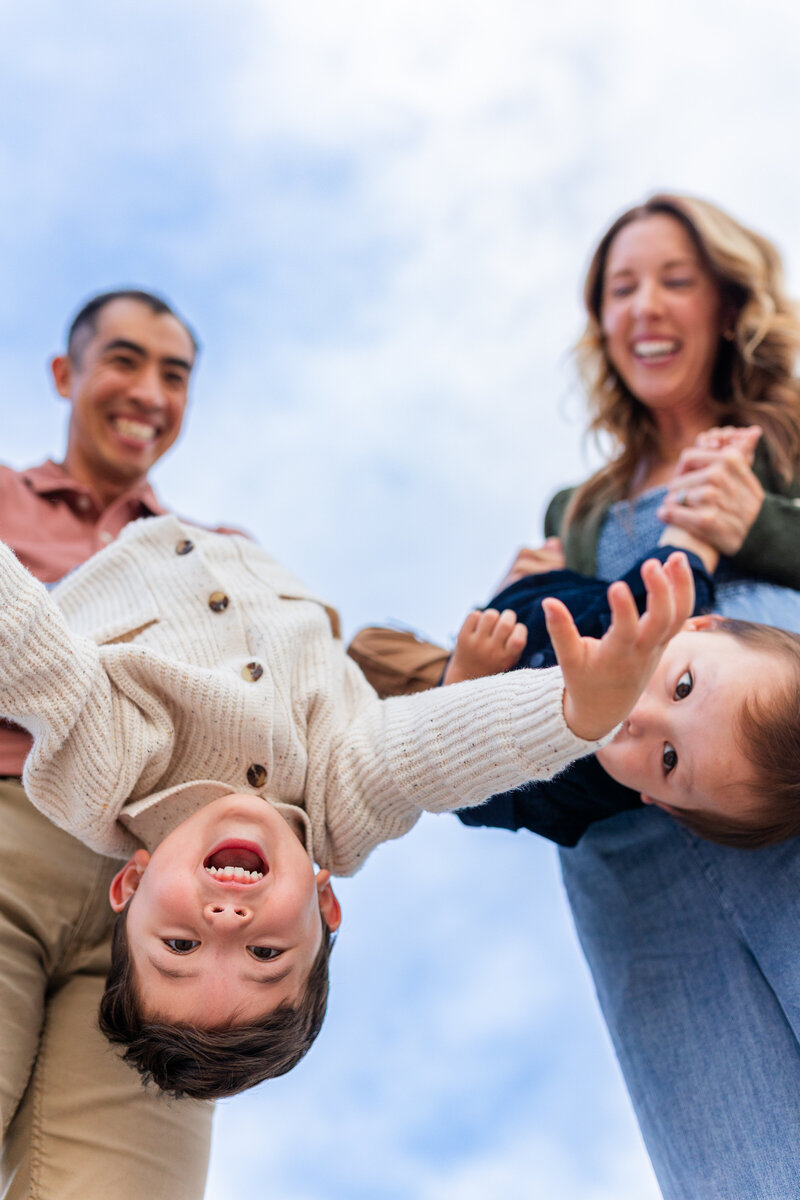 family walking in bushes for family photos in the fall