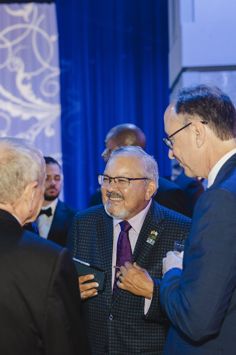 People at a conference smiling at each other while talking 