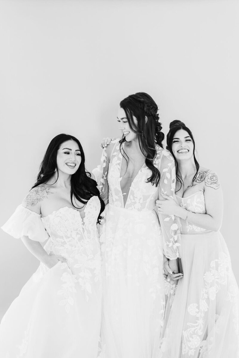 three brides trying on a dress