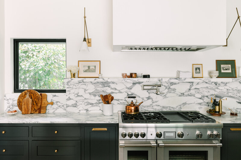 Kitchen with Farrow and Ball Railings cabinets and Corchia marble counter and backsplash, drywall hood and Thermador appliances.